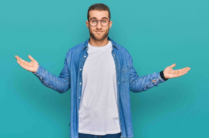 Young caucasian man wearing casual clothes clueless and confused expression with arms and hands raised. doubt concept.